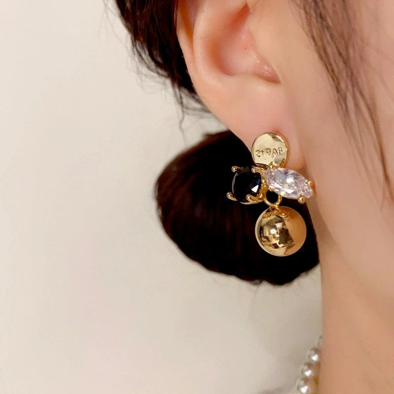 Model showcasing the dangle and style of the 14K Gold Plated Zircon Ball Earrings