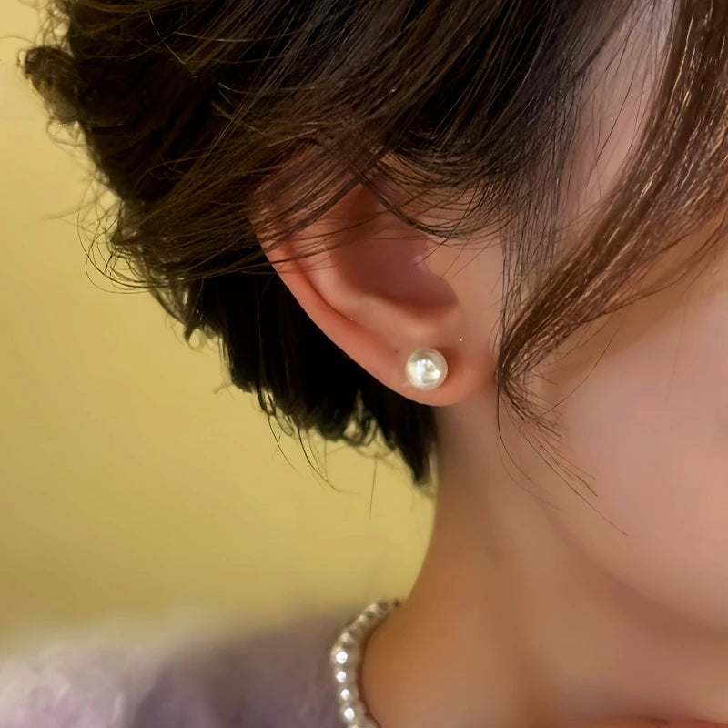 Close-up detail of the sparkling zircons and plating on the gold pearl earrings