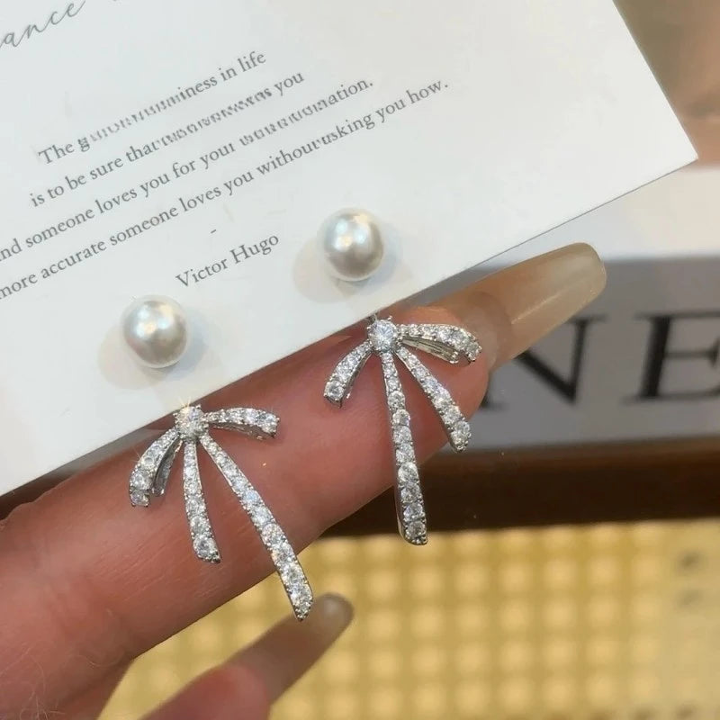 Angled view of the 14K Gold Plated Zircon Bow Pearl Earrings