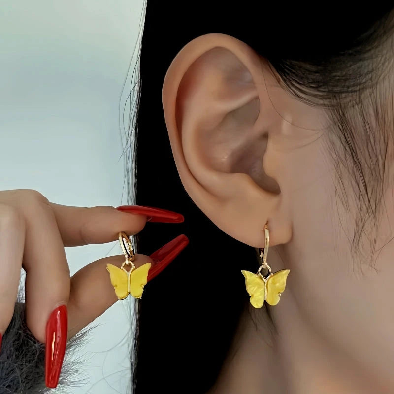 Model showcasing the dangle and style of the 14K Gold Plated Zircon Butterfly Earrings