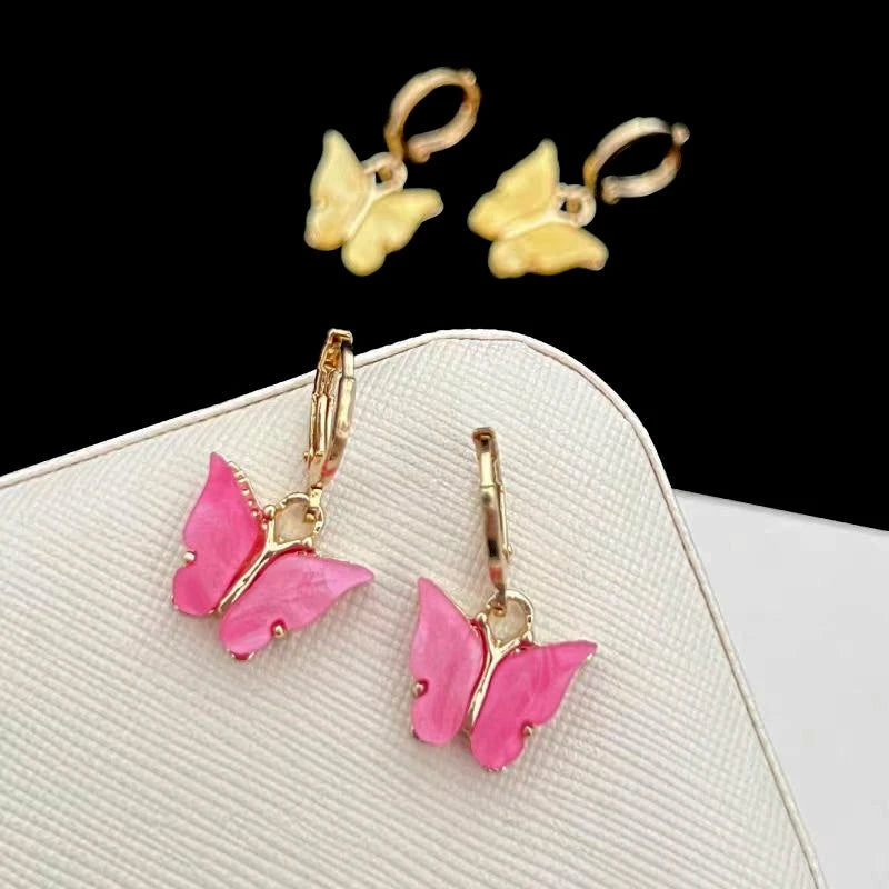 Close-up detail of the sparkling zircons and plating on the gold butterfly earrings