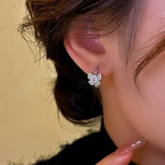 Close-up detail of the sparkling zircons and plating on the gold hoop earrings