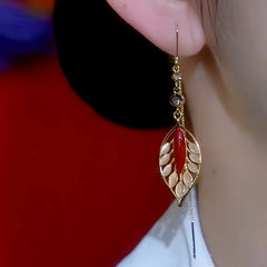 Model showcasing the dangle and style of the 14K Gold Plated Zircon Cat's Eye Leaf Tassel Threader Earrings
