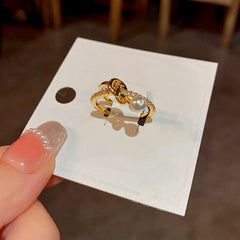 Close-up view of the gemstone and setting of the Gold Cross Ring