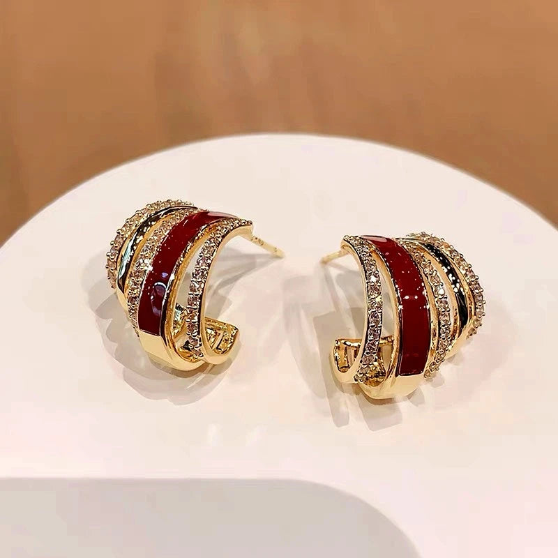 Close-up detail of the sparkling zircons and plating on the gold hoop earrings