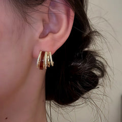 Model showcasing the dangle and style of the 14K Gold Plated Zircon Drip Glaze Multi-Layer C-Shaped Earrings
