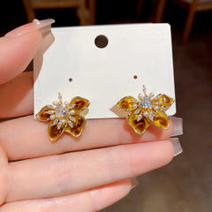 Angled view of the 14K Gold Plated Zircon Flower Stamen Earrings
