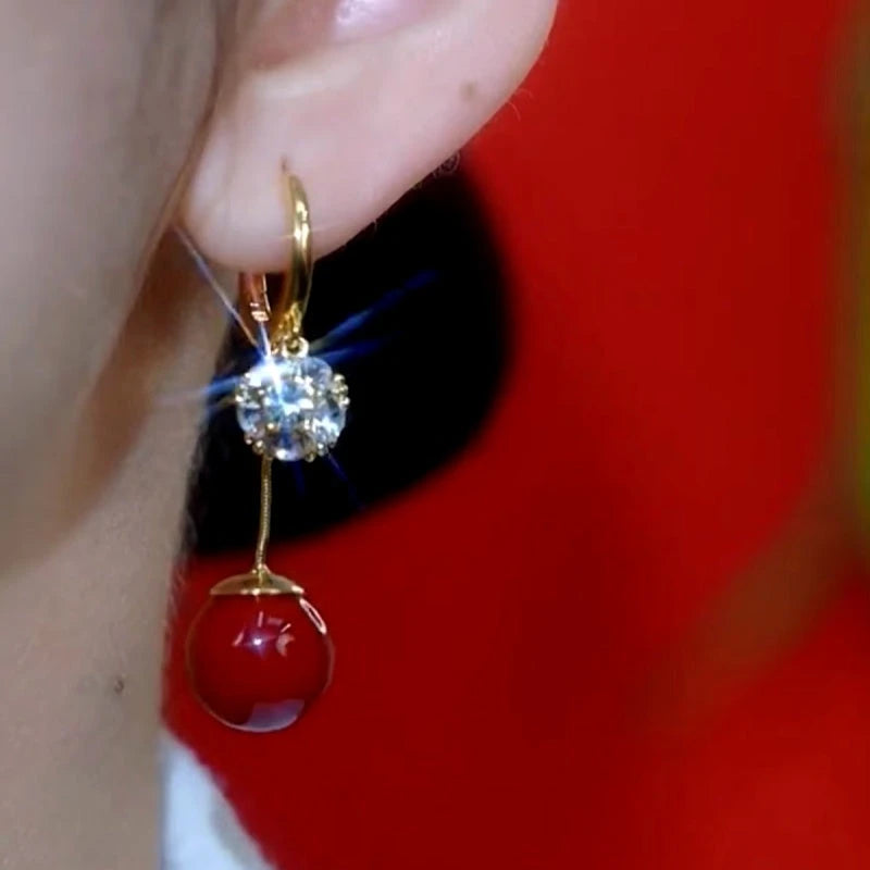 Close-up detail of the sparkling zircons and plating on the red drop earrings