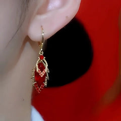 Model showcasing the dangle and style of the 14K Gold Plated Zircon Red Diamond Lead Earrings