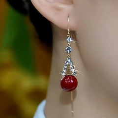 Close-up detail of the sparkling zircons and plating on the gold threader earrings