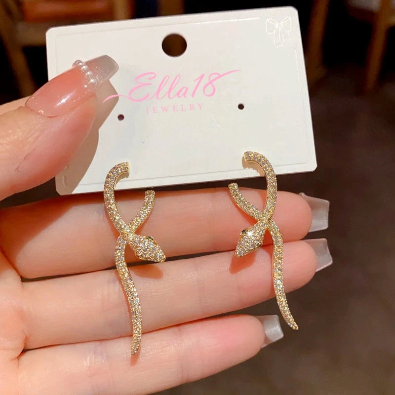 Model showcasing the dangle and style of the 14K Gold Plated Zircon Snake Earrings