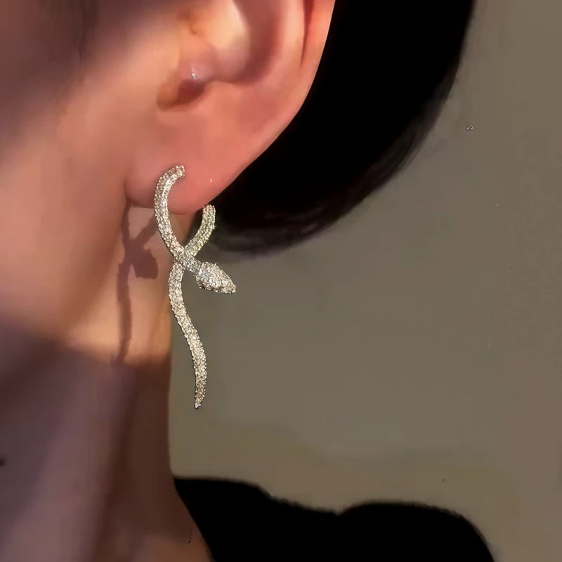Close-up detail of the sparkling zircons and plating on the gold snake earrings