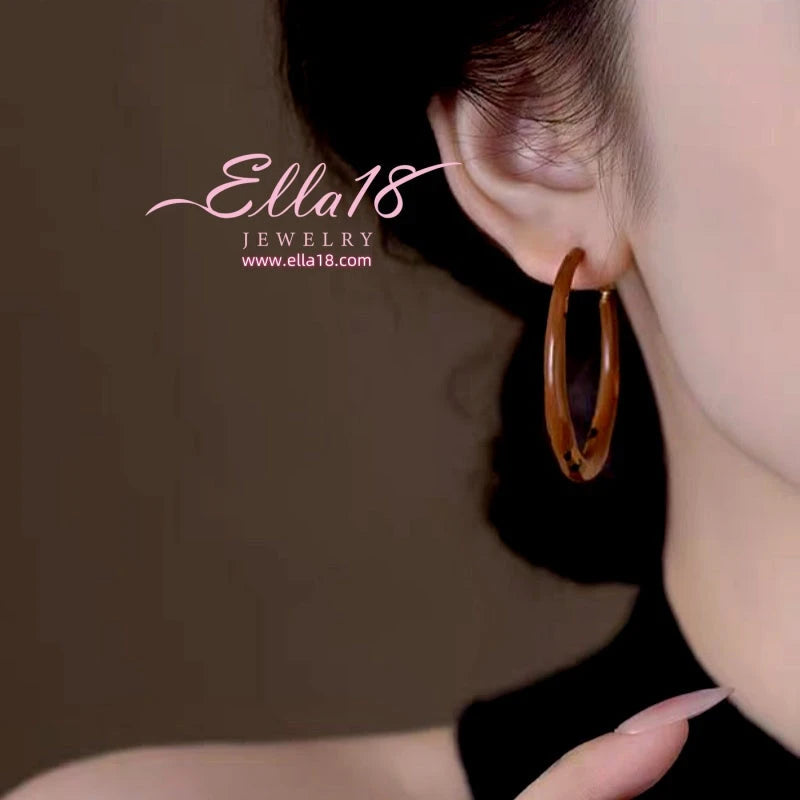 Close-up detail of the sparkling zircons and plating on the Leopard Print Hoops