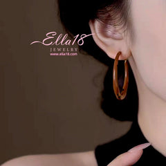 Close-up detail of the sparkling zircons and plating on the Leopard Print Hoops