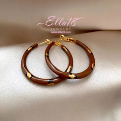 Model showcasing the dangle and style of the 14K Gold-Plated Luxury Brown Drip Glaze Polka Dot Leopard Print Hoop Earrings