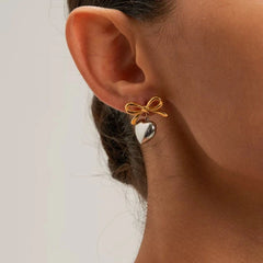Model showcasing the dangle and style of the 18K Gold-Plated Bow Heart Earrings