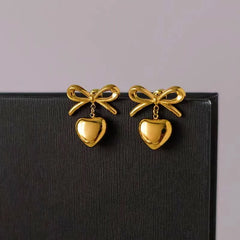 Angled view of the 18K Gold-Plated Bow Heart Earrings