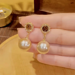 Close-up detail of the sparkling zircons and plating on the Pearl Earrings