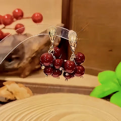 Close-up detail of the sparkling zircons and plating on the Grape Earrings