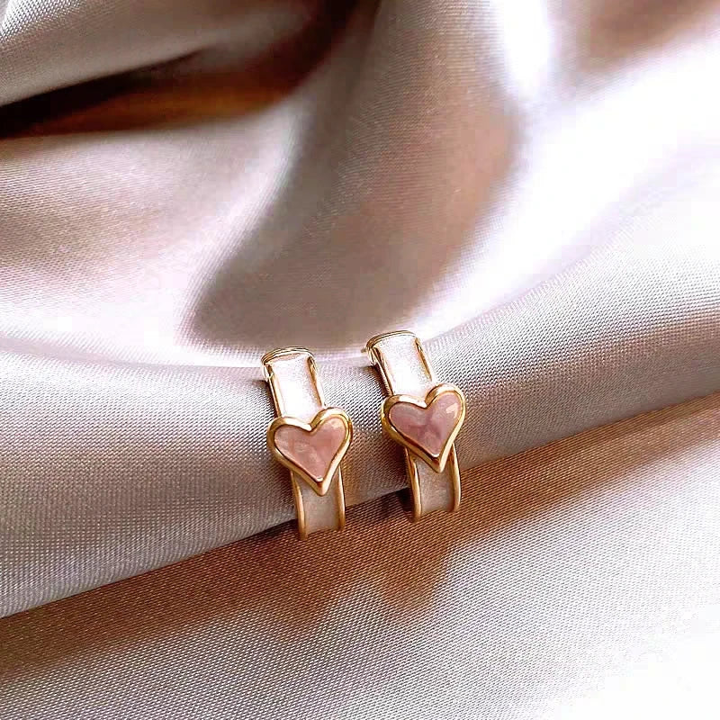 Model showcasing the dangle and style of the 18K Gold-Plated C-Ring Glaze Heart Earrings