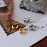 Gold and silver small chunky C-shaped hoop stud earrings flat lay product display
