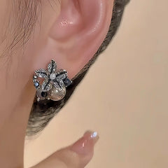 Model showcasing the dangle and style of the 18K Gold-Plated Diamond Stafish Stud Earrings