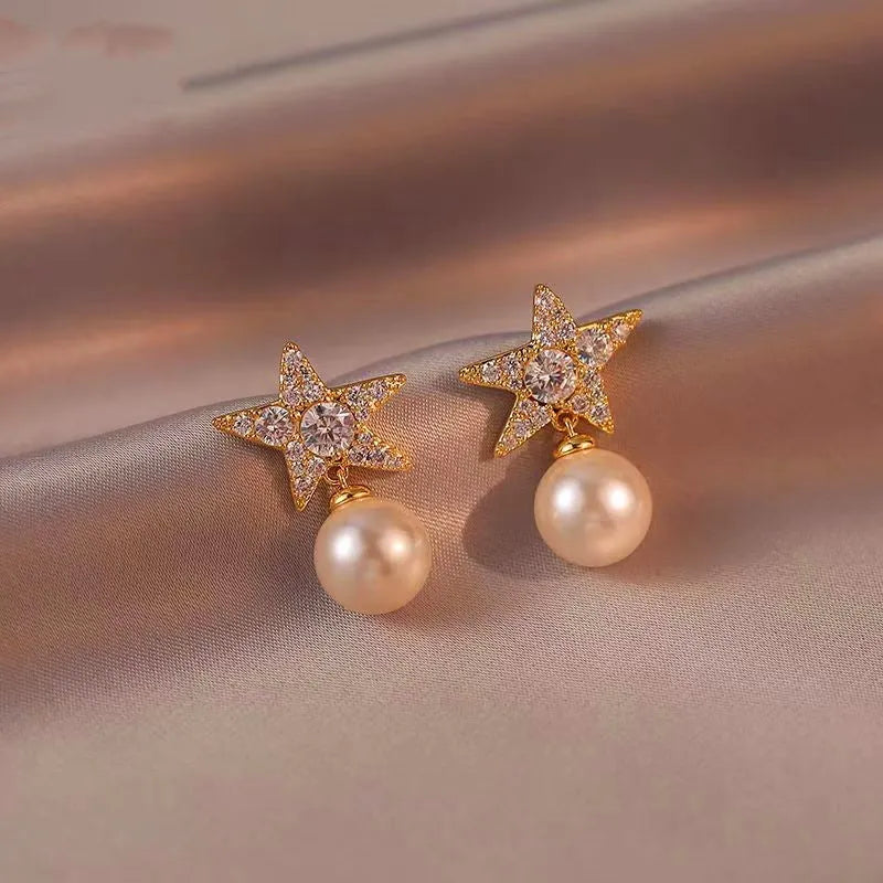 Angled view of the 18K Gold-Plated Diamond Star Pearl Earrings