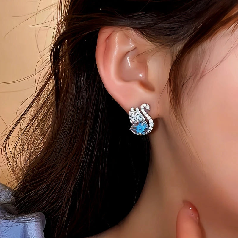 Model showcasing the dangle and style of the 18K Gold-Plated Diamond Swan Earrings