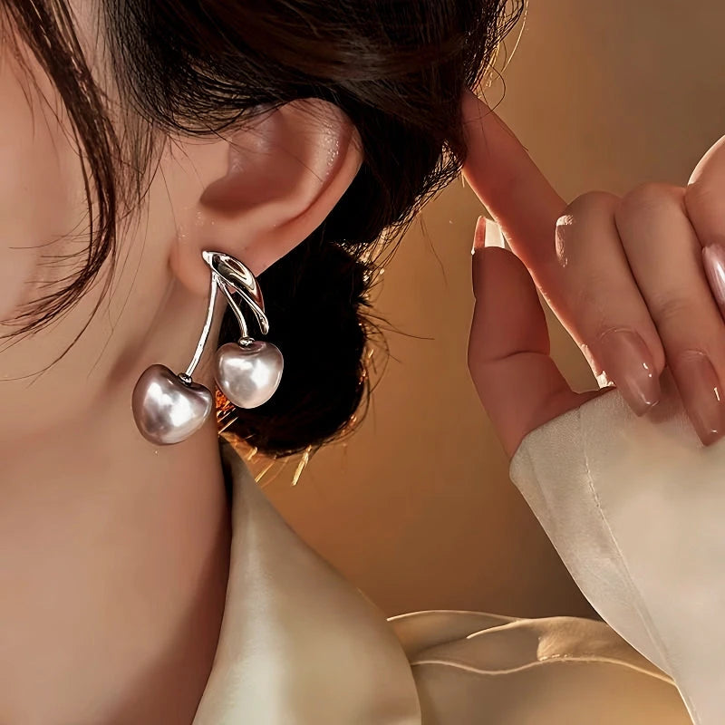 Model showcasing the dangle and style of the 18K Gold-Plated Elegant Cherry Earrings