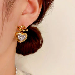 Close-up detail of the sparkling zircons and plating on the Heart Earrings