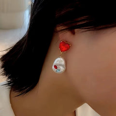 Model showcasing the dangle and style of the 18K Gold-Plated Elegant Red Heart Crystal Pearl Earrings