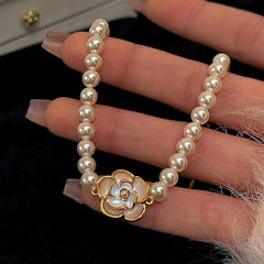 Model wearing the 18K Gold-Plated Exquisite Pearl Camellia Bracelet to highlight its design on the wrist