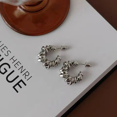 Model showcasing the dangle and style of the 18K Gold-Plated Hollow C-Shaped Earrings