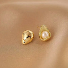 Front and back view of teardrop gold pearl stud earrings on silk fabric