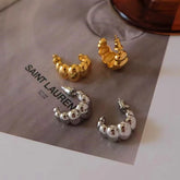 Gold and silver chunky beaded C-shaped hoop earrings flat lay product shot