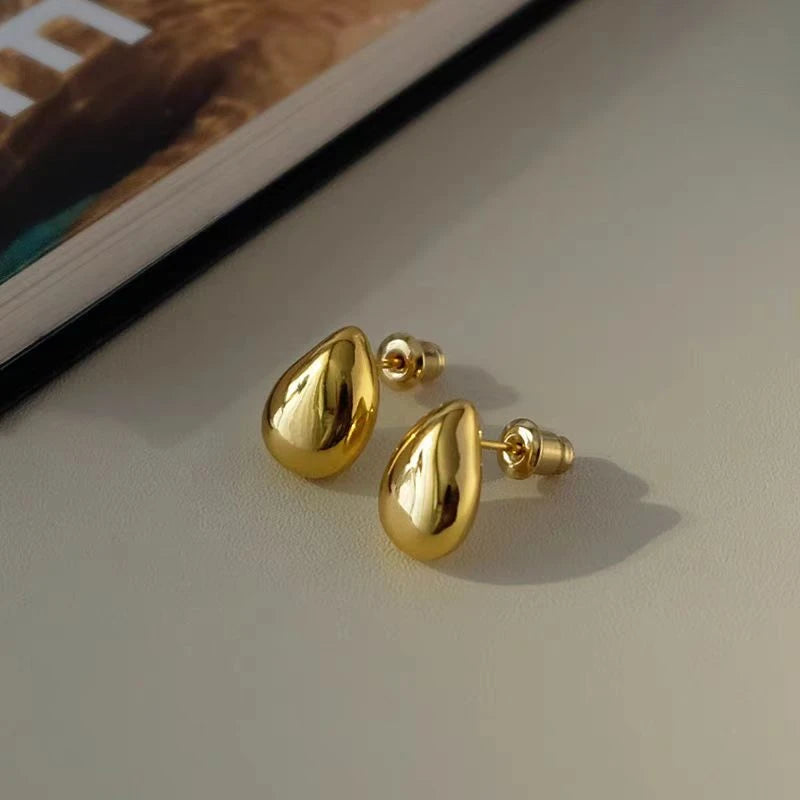 Model showcasing the dangle and style of the 18K Gold-Plated Water Drop Stud Earrings
