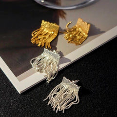 Gold and silver beaded chain tassel stud earrings flat lay display
