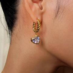 Gold twisted huggie hoop heart cubic zirconia drop earring on ear