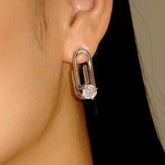 Silver paperclip cubic zirconia stud earring on ear side view