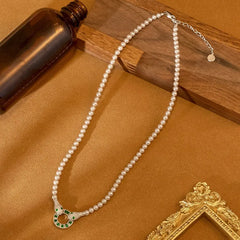 White Pearl Necklace with Silver Snake Pendant and Green Gemstones