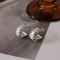 Close-up detail of the sparkling zircons and plating on the C-Shaped Earrings