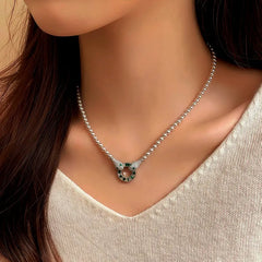 Pearl necklace with double snake head green gem circle pendant, worn on neck