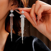 Silver Baguette Crystal Long Tassel Dangle Earrings, One Worn on Ear, One Held by Hand