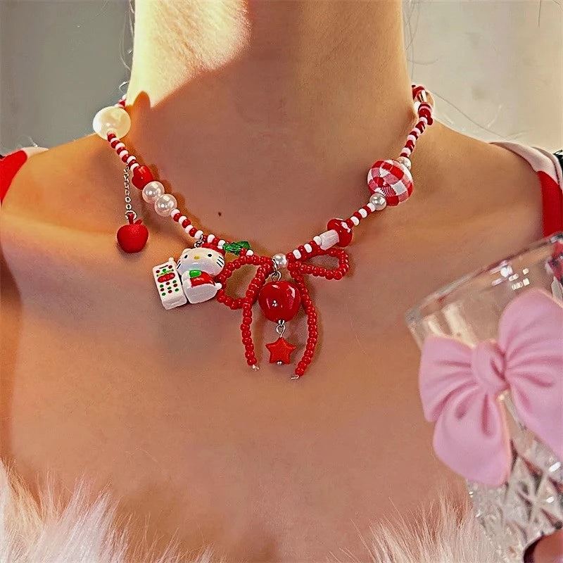 Christmas Red Bow Beaded Kt Cat Necklace worn to showcase its length and pendant detail