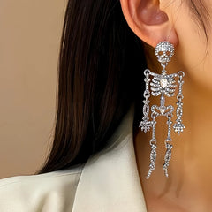 Model showcasing the dangle and style of the Halloween 14K Gold-Plated Skull Earrings