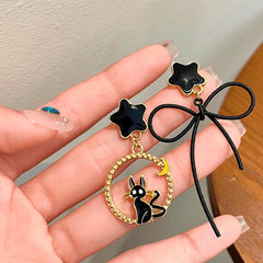 Angled view of the Halloween 14K Gold-Plated Star Bow Cat Earrings