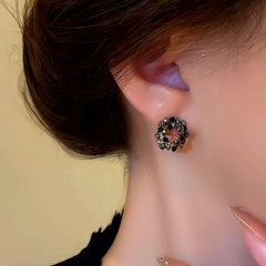 Model showcasing the dangle and style of the Silver Post Black Diamond Hoop Earrings
