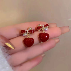 Angled view of the Silver Post Bow Heart Earrings