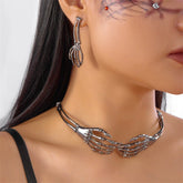 Gothic silver skeleton hand choker and matching earring worn on model, punk jewelry