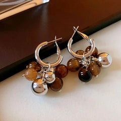 Angled view of the Silver Post Resin Ball Tassel Earrings